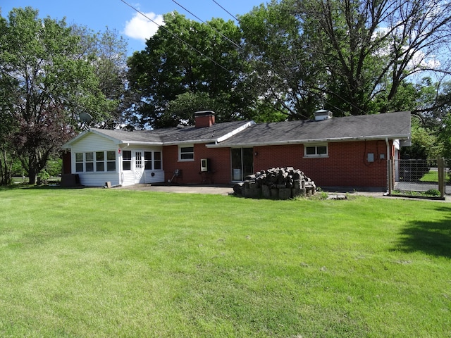 back of house with a lawn