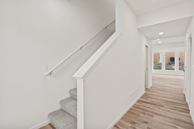 stairway with hardwood / wood-style floors