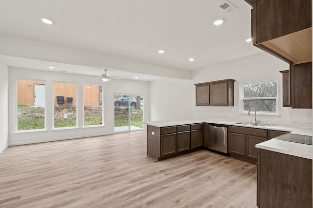 kitchen featuring kitchen peninsula, a healthy amount of sunlight, sink, dishwasher, and light hardwood / wood-style floors