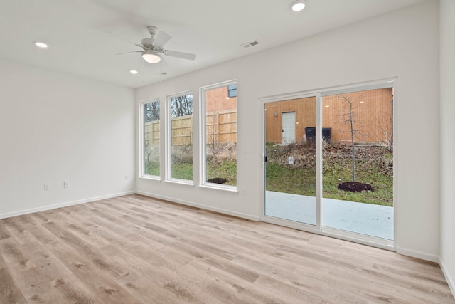 unfurnished room with light wood-type flooring and ceiling fan