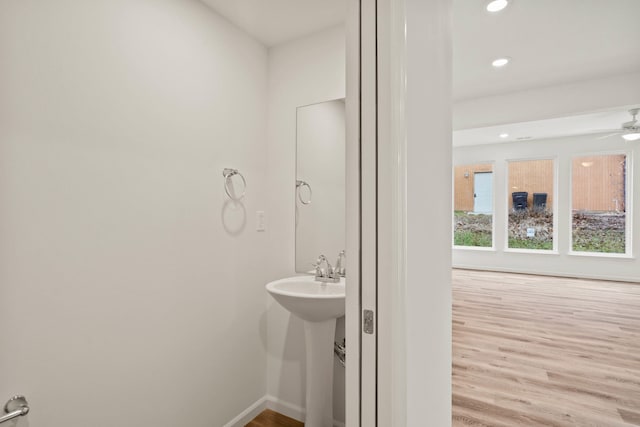 bathroom with ceiling fan and hardwood / wood-style flooring