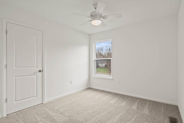 spare room with carpet flooring and ceiling fan