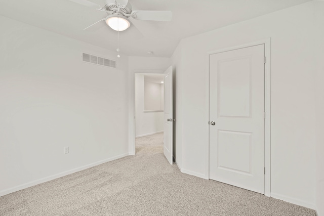 unfurnished bedroom with ceiling fan and light carpet