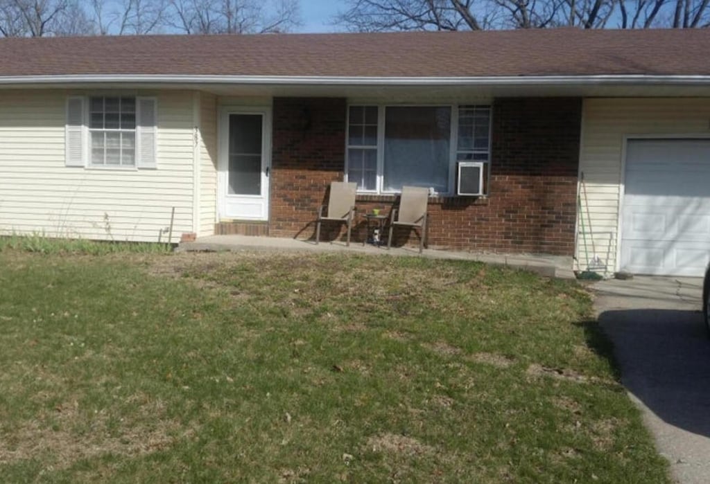 exterior space featuring a garage and a yard