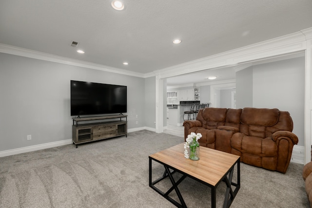 carpeted living room with ornamental molding