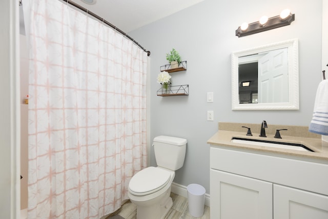 bathroom with vanity, toilet, and tile floors