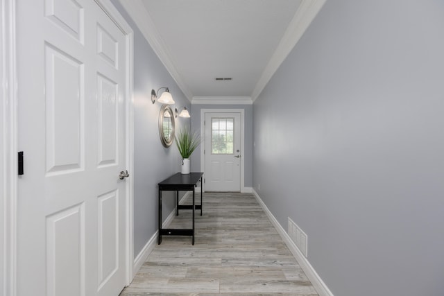 entryway featuring crown molding and light wood-type flooring