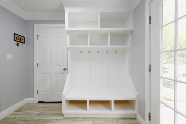 mudroom featuring ornamental molding and light hardwood / wood-style floors