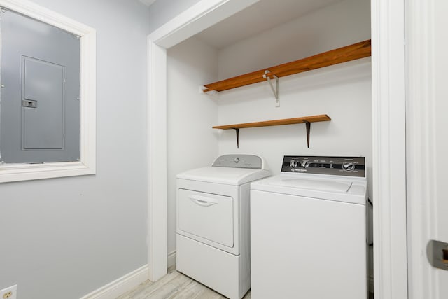 clothes washing area with light wood-type flooring and washing machine and clothes dryer