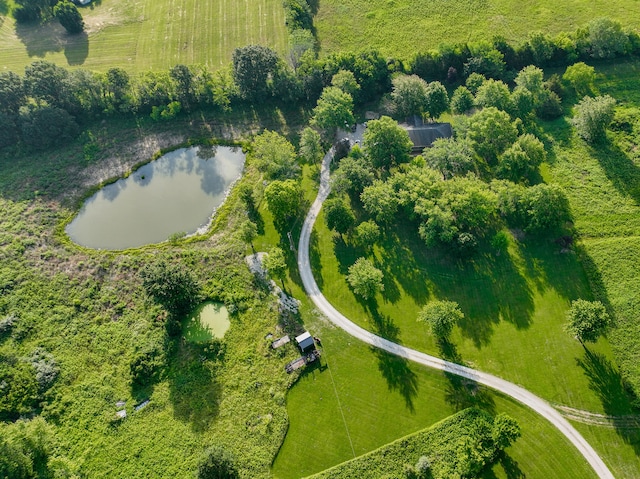 birds eye view of property with a water view and a rural view