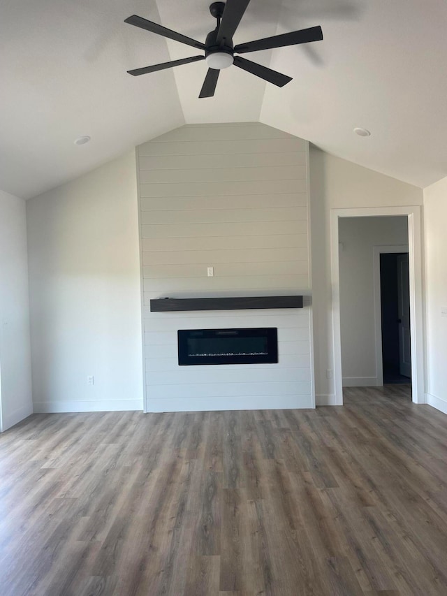 unfurnished living room featuring ceiling fan, hardwood / wood-style flooring, a fireplace, and vaulted ceiling