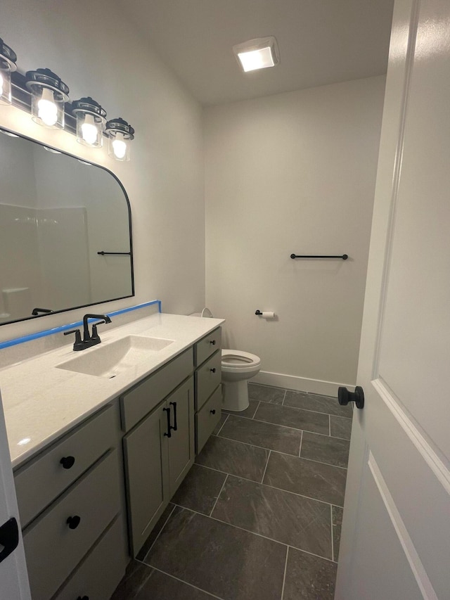 bathroom featuring tile patterned floors, toilet, and vanity