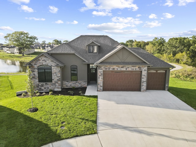 view of front facade with a water view, a front yard, and a garage