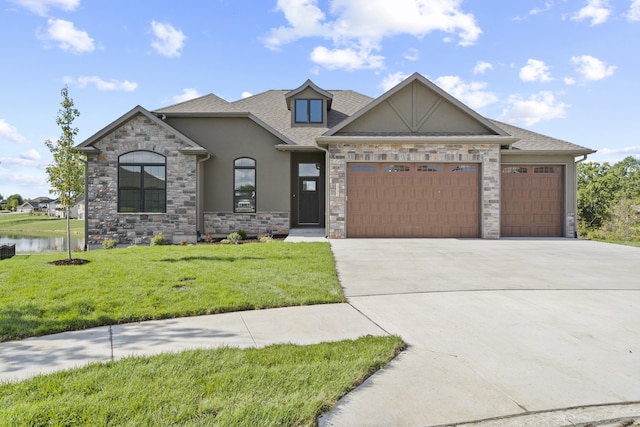 view of front facade featuring a water view, a front yard, and a garage