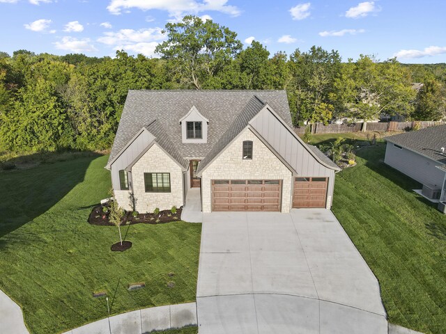 1704 Stillpoint Ct, Columbia, MO 65203 - view of front facade with an attached garage, driveway, a front lawn, brick siding, and a shingled roof