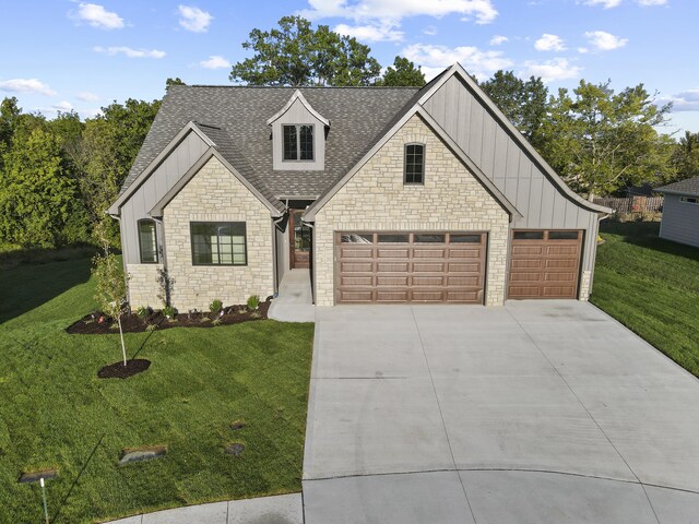 1704 Stillpoint Ct, Columbia, MO 65203 - view of front facade featuring stone siding, board and batten siding, a front yard, and a shingled roof