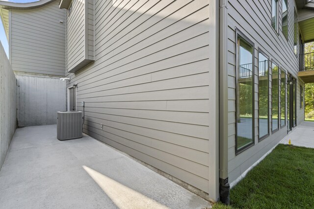 1704 Stillpoint Ct, Columbia, MO 65203 - view of side of property featuring central AC, fence, and a patio