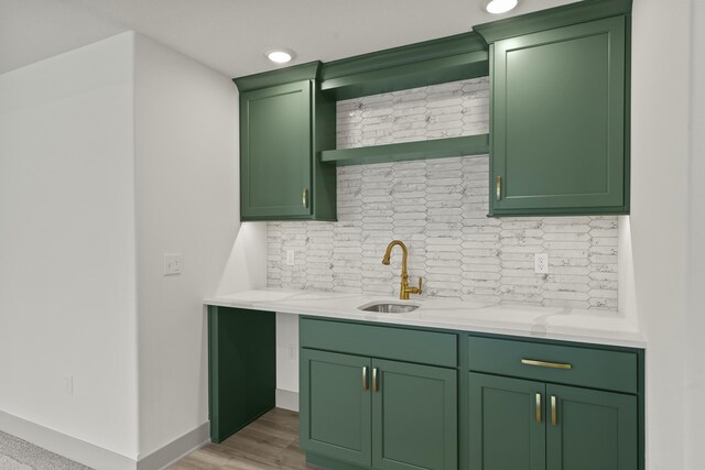 1704 Stillpoint Ct, Columbia, MO 65203 - bar with a sink, tasteful backsplash, baseboards, and light wood finished floors