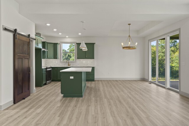 1704 Stillpoint Ct, Columbia, MO 65203 - kitchen featuring light countertops, light wood-style flooring, decorative backsplash, green cabinetry, and range with electric cooktop