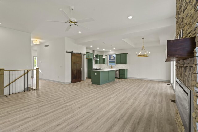 1704 Stillpoint Ct, Columbia, MO 65203 - interior space featuring green cabinetry, backsplash, a fireplace, a barn door, and open floor plan