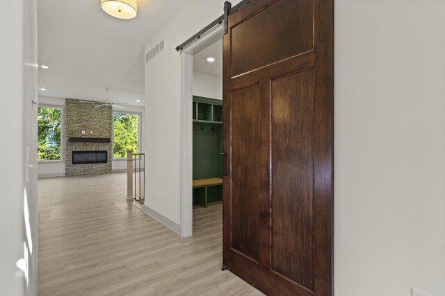 1704 Stillpoint Ct, Columbia, MO 65203 - hallway featuring a barn door, light wood-style flooring, baseboards, visible vents, and recessed lighting