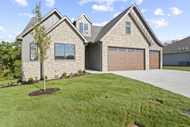 1704 Stillpoint Ct, Columbia, MO 65203 - craftsman-style house featuring stone siding, concrete driveway, a front yard, board and batten siding, and roof with shingles