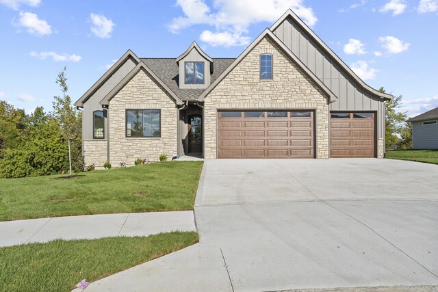 1704 Stillpoint Ct, Columbia, MO 65203 - craftsman-style house featuring driveway, a front yard, stone siding, an attached garage, and board and batten siding