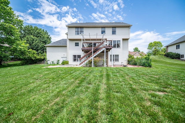 back of house featuring a wooden deck, a yard, and a patio