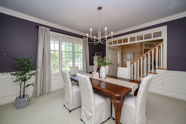 dining area featuring carpet, ornamental molding, and a notable chandelier