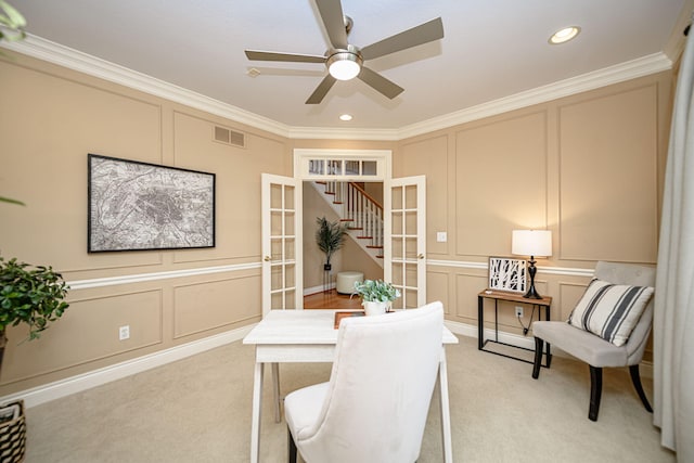 carpeted office space featuring ceiling fan, french doors, and ornamental molding