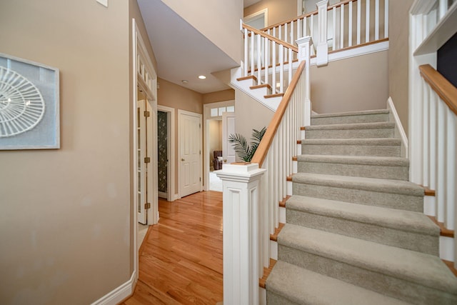 stairs featuring hardwood / wood-style floors