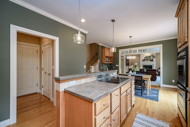 kitchen with black electric stovetop, ornamental molding, light hardwood / wood-style flooring, and decorative light fixtures