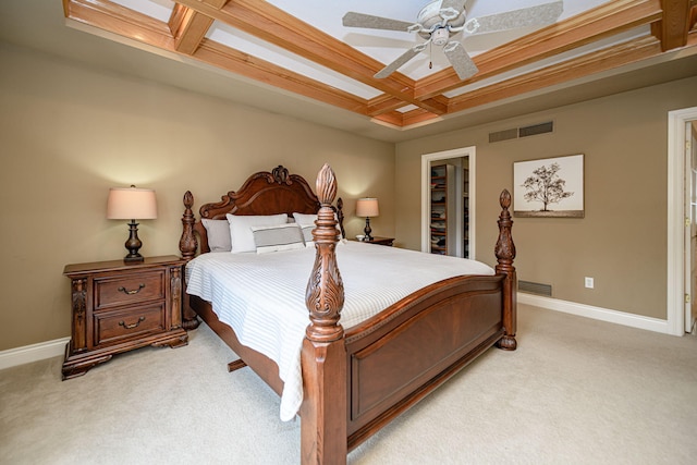 carpeted bedroom with a spacious closet, ceiling fan, a closet, and coffered ceiling