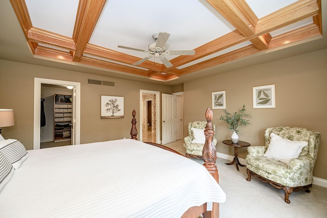 carpeted bedroom featuring ceiling fan, a closet, and coffered ceiling