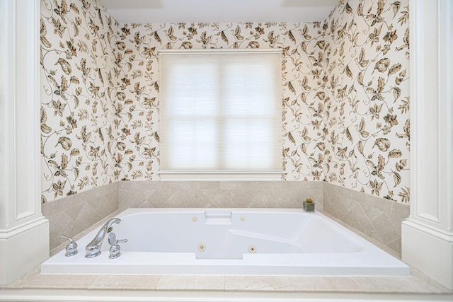 bathroom with ornate columns and a relaxing tiled tub