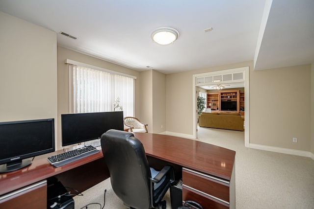 office area with ceiling fan and carpet