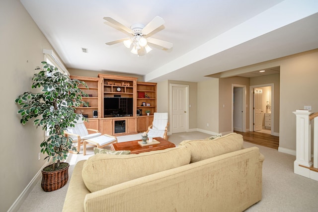 carpeted living room featuring ceiling fan