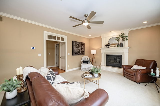 living room featuring carpet floors, a large fireplace, crown molding, and ceiling fan