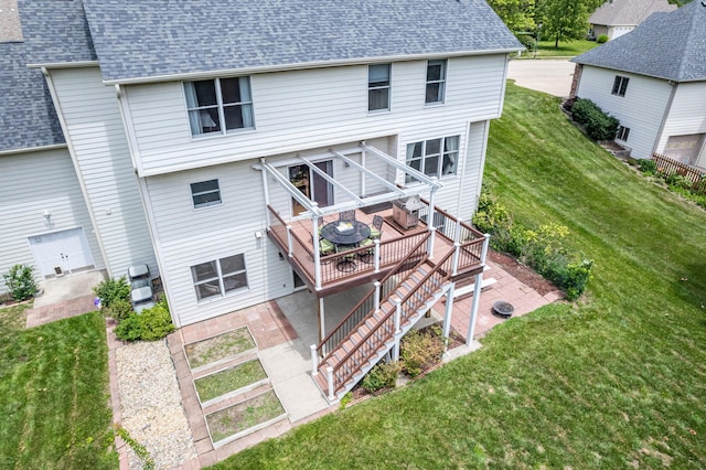 rear view of property featuring a yard, a deck, and a patio