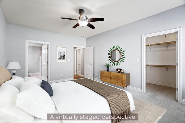 1703 Linkside Dr, Columbia, MO 65201 - carpeted bedroom featuring a spacious closet, baseboards, a closet, ensuite bath, and ceiling fan