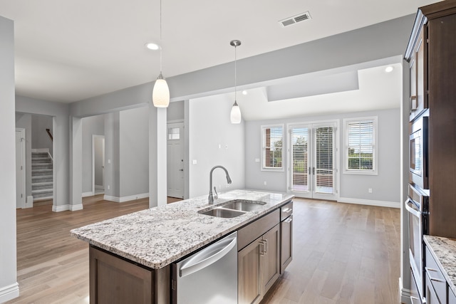 1703 Linkside Dr, Columbia, MO 65201 - kitchen with stainless steel appliances, a sink, open floor plan, light wood-style flooring, and recessed lighting