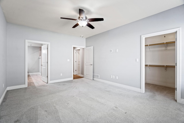 1703 Linkside Dr, Columbia, MO 65201 - unfurnished bedroom with carpet, a spacious closet, baseboards, and ensuite bath