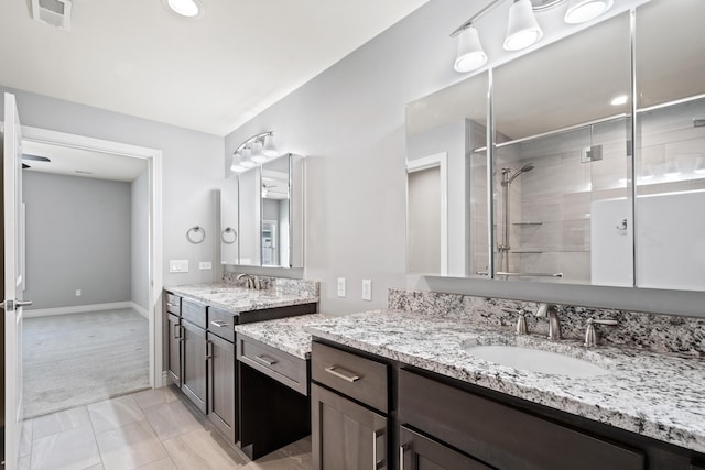 1703 Linkside Dr, Columbia, MO 65201 - bathroom with two vanities, a stall shower, baseboards, and recessed lighting