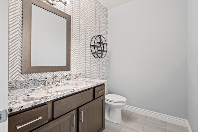 1703 Linkside Dr, Columbia, MO 65201 - bathroom with wallpapered walls, baseboards, vanity, and toilet