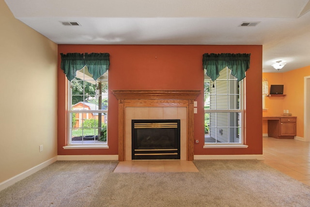 604 Adens Woods Ct, Columbia, MO 65201 - unfurnished living room with a tiled fireplace, carpet flooring, and tile patterned flooring