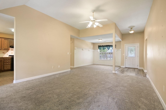 604 Adens Woods Ct, Columbia, MO 65201 - unfurnished living room featuring light colored carpet, ceiling fan, and vaulted ceiling