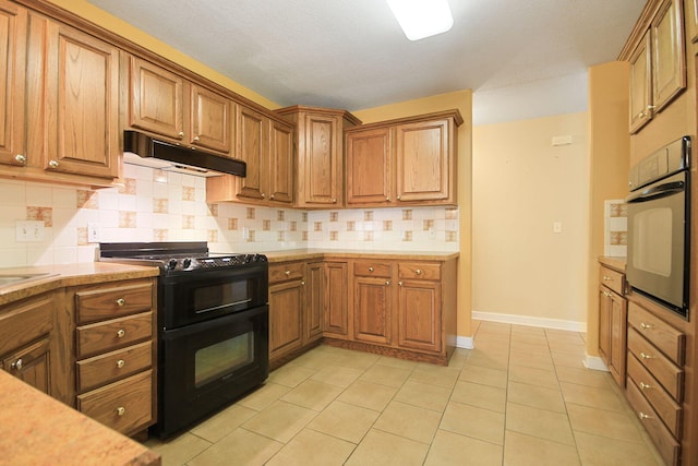 604 Adens Woods Ct, Columbia, MO 65201 - kitchen with black appliances, under cabinet range hood, brown cabinets, and light countertops