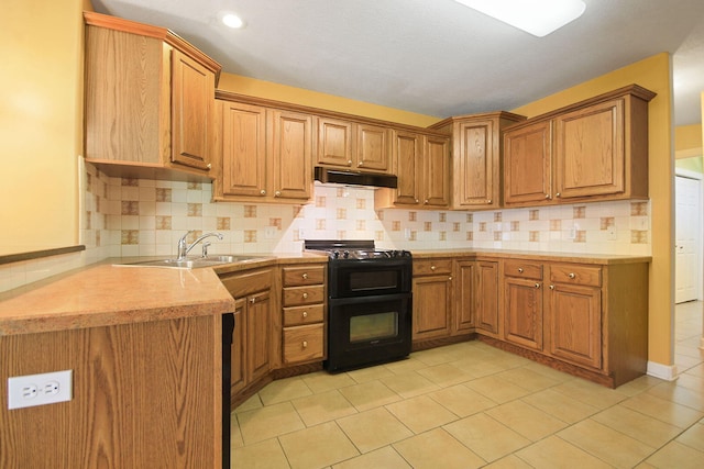 604 Adens Woods Ct, Columbia, MO 65201 - kitchen with black gas range oven, under cabinet range hood, light countertops, and tasteful backsplash
