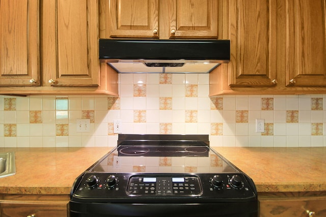 604 Adens Woods Ct, Columbia, MO 65201 - kitchen featuring under cabinet range hood, black / electric stove, light countertops, and brown cabinetry
