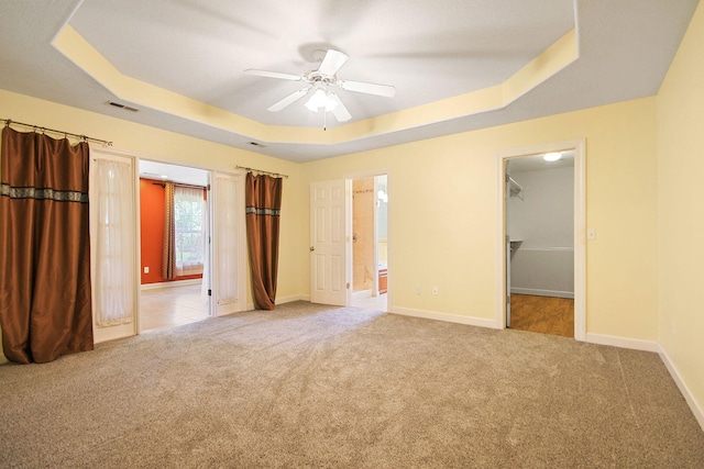 604 Adens Woods Ct, Columbia, MO 65201 - unfurnished bedroom featuring a raised ceiling, carpet, a spacious closet, and ensuite bath